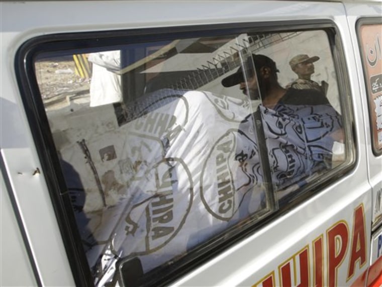 The dead body of Moeed Abdul Salam who killed himself with a grenade during a paramilitary raid on his apartment, is taken away in an ambulance in Karachi, Pakistan, in this Nov. 18, 2011 photo.
